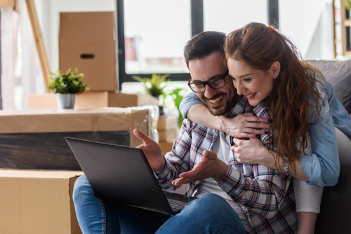 happy couple reading online reviews